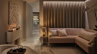 The Spa at One Aldwych, in soft pastel hues with dim lighting, a seated area and tray of tea