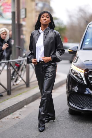 woman wearing leather jacket, button-down, and leather pants