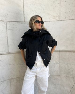 Eliza Huber wearing a black technical Proenza Schouler jacket with white carpenter jeans.