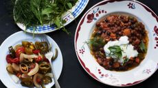 A bowl of spice beans topped with yoghurt and herbs