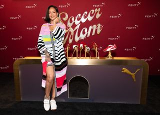 Rihanna wears a striped Christopher John Rogers dress with Avanti Puma sneakers for a press conference in Los Angeles