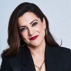 a head shot of girls who code founder reshma saujani as she wears a blazer and red lipstick