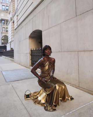 Woman wearing gold maxi dress.