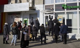 Customers wait outside a PrivatBank branch in Melitopol, Ukraine on February 15, 2022, just days before the Russian invasion.