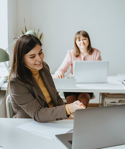 Two business women on computers