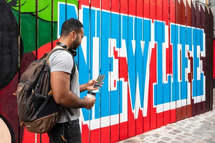 A person checking their work on mobile in the street