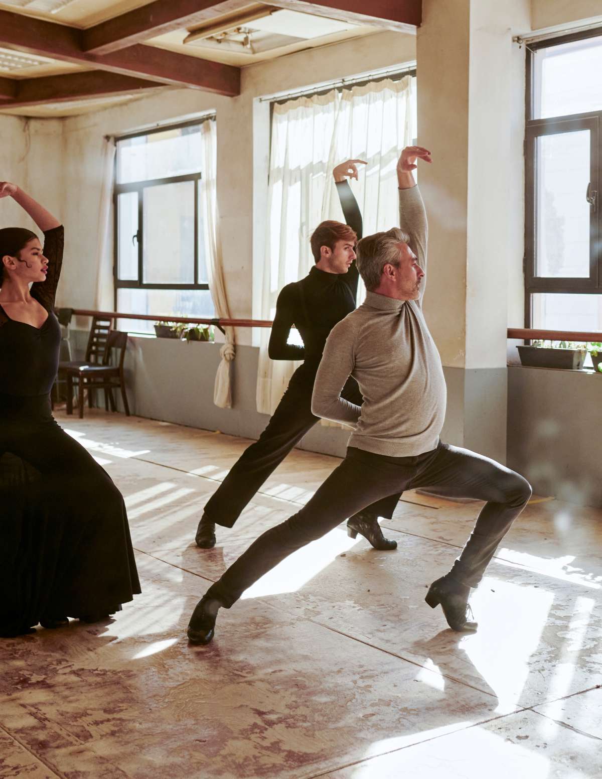 Small business dance class man instructing two women