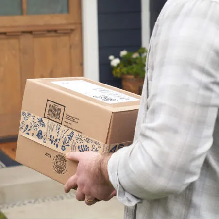 A delivery package box in hands of a man.