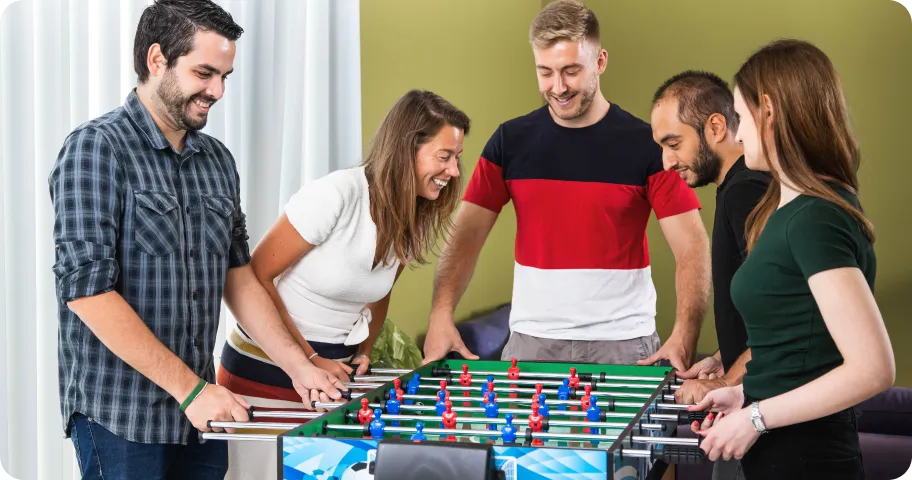 Deriv employees playing foosball