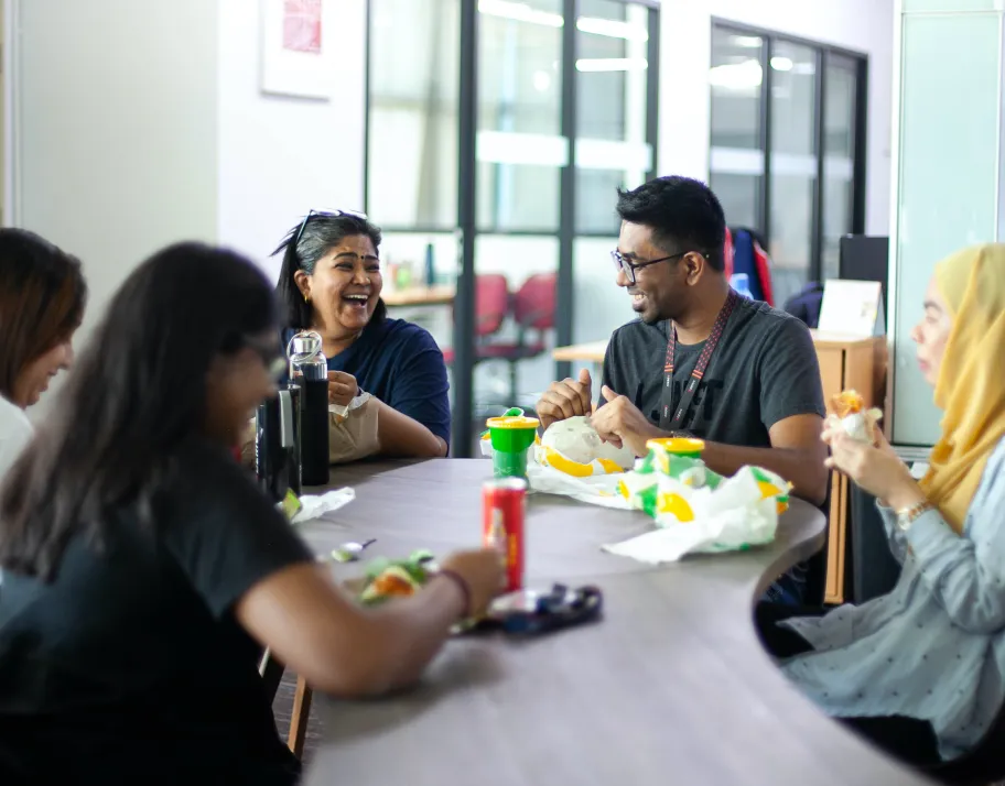 Deriv employees chatting and having lunch together