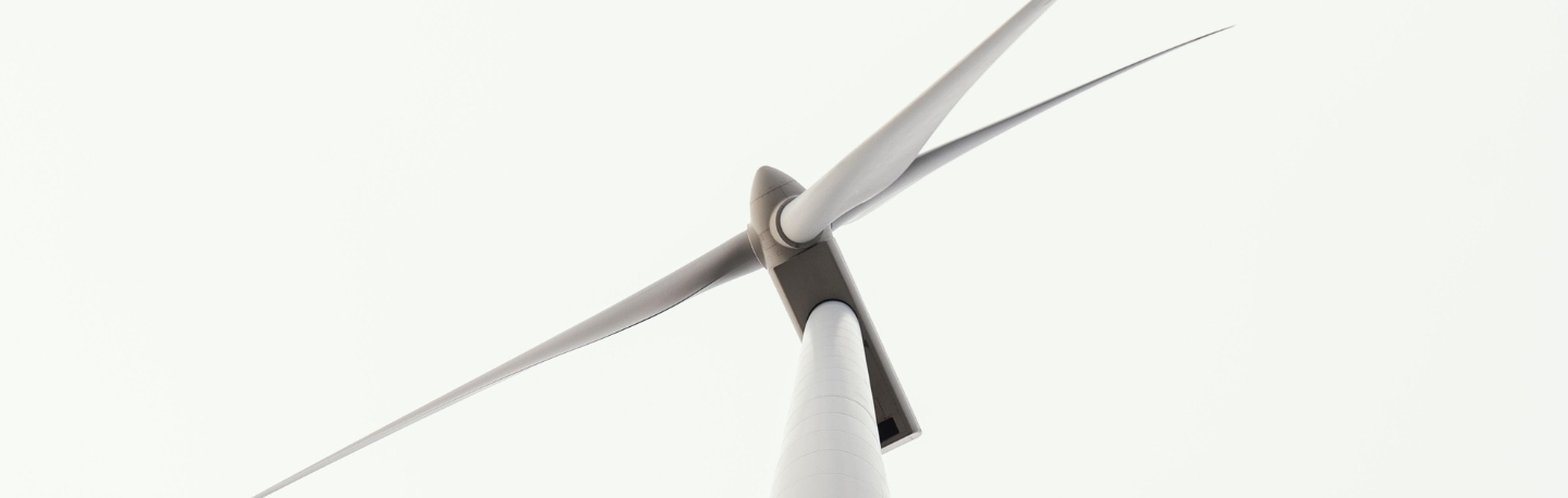 a partial view of a large white wind turbine