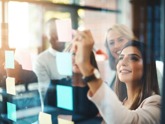 stock photo: coworkers writing on post-its