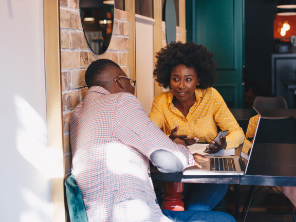 stock photo: coworkers in a cafe with a laptop