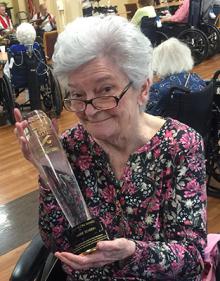 Marie Severin holding award