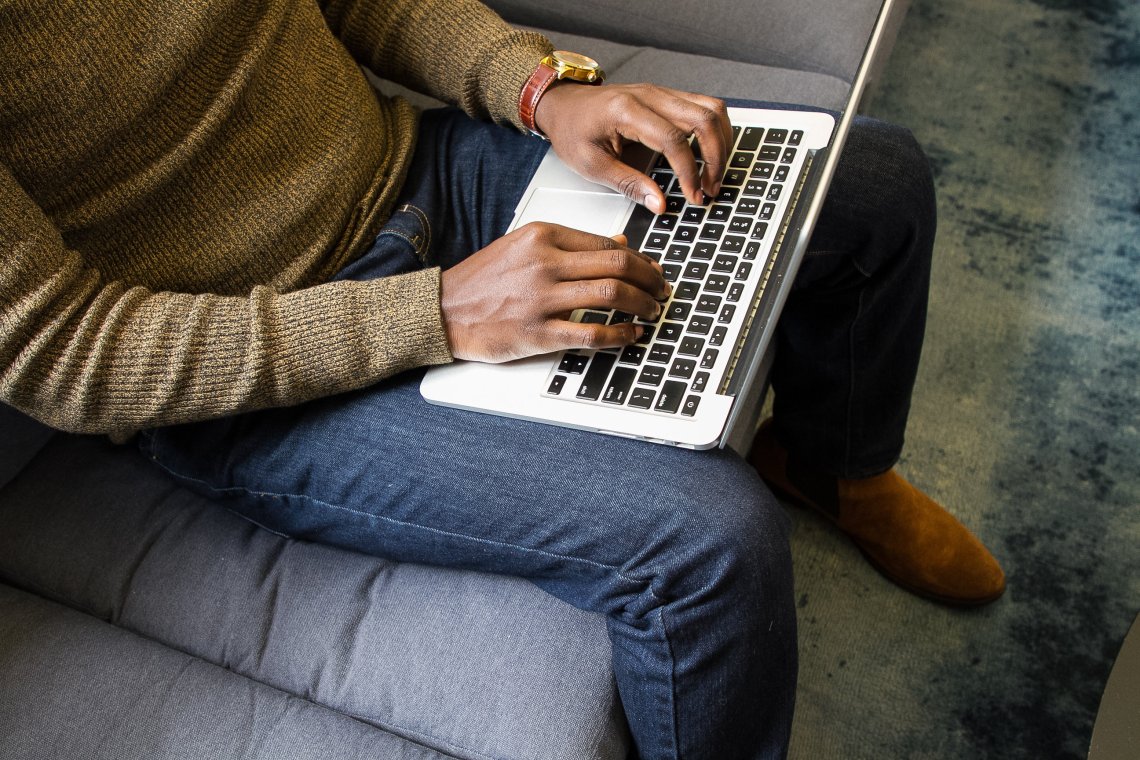 [IMAGE] A pair of brown-skinned hands are typing on a laptop. The face of the typist isn't visible.