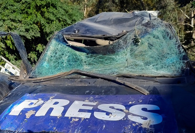 A damaged car marked with 'Press' at the site of an Israeli strike that killed a few journalists and wounded several others as they slept in guesthouses used by media in Hasbaya in southern Lebanon on October 25, 2024