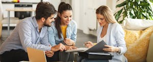 Female Real Estate agent offers insurance to young couple.