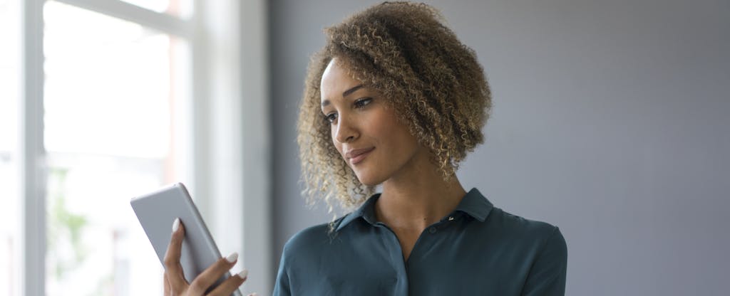 Young businesswoman using digital tablet in office