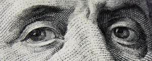 Close-up of a U.S. $100 bill, showing Benjamin Franklins eyes