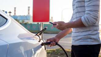 Man charges an electric car | Photo 174498068 © Shao-chun Wang | Dreamstime.com