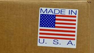 Made in the USA sticker on a cardboard box | Photo 211759497 © Brett Hondow | Dreamstime.com