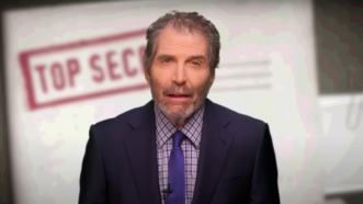 John Stossel is seen in front of a document labeled top secret | Stossel TV