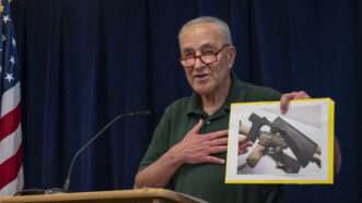 Chuck Schumer holds picture of bump stock | Ron Adar, M10s/ZUMAPRESS/Newscom