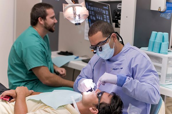 faculty and dental students talking