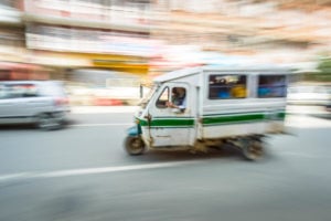 A three-wheeler car with motion blur