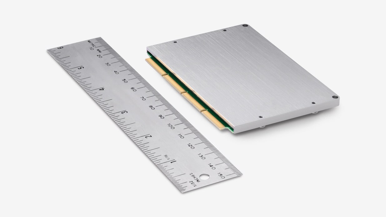 NUC compute element with a heatsink cover and  a ruler next to it.