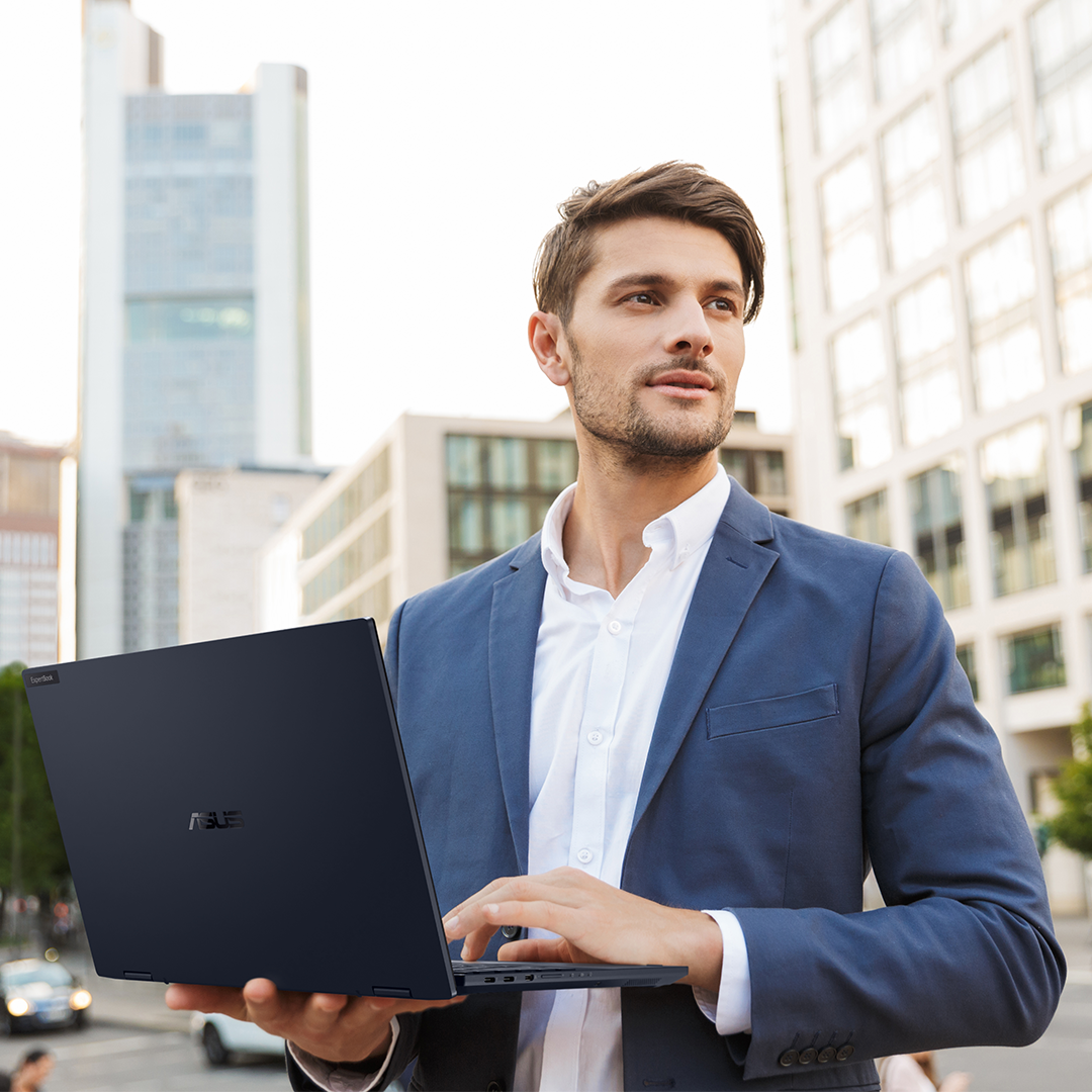 A business man is using ASUS ExpertBook laptop on the road.