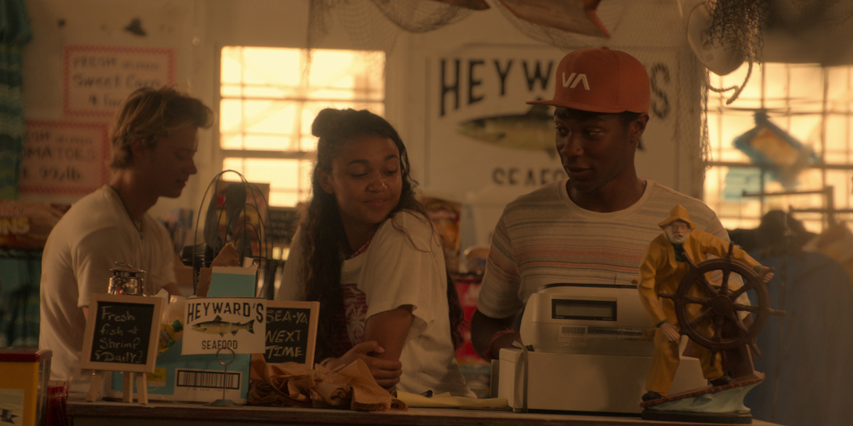 JJ, Kiara, and Pope stand inside Heyward's Seafood restaurant.