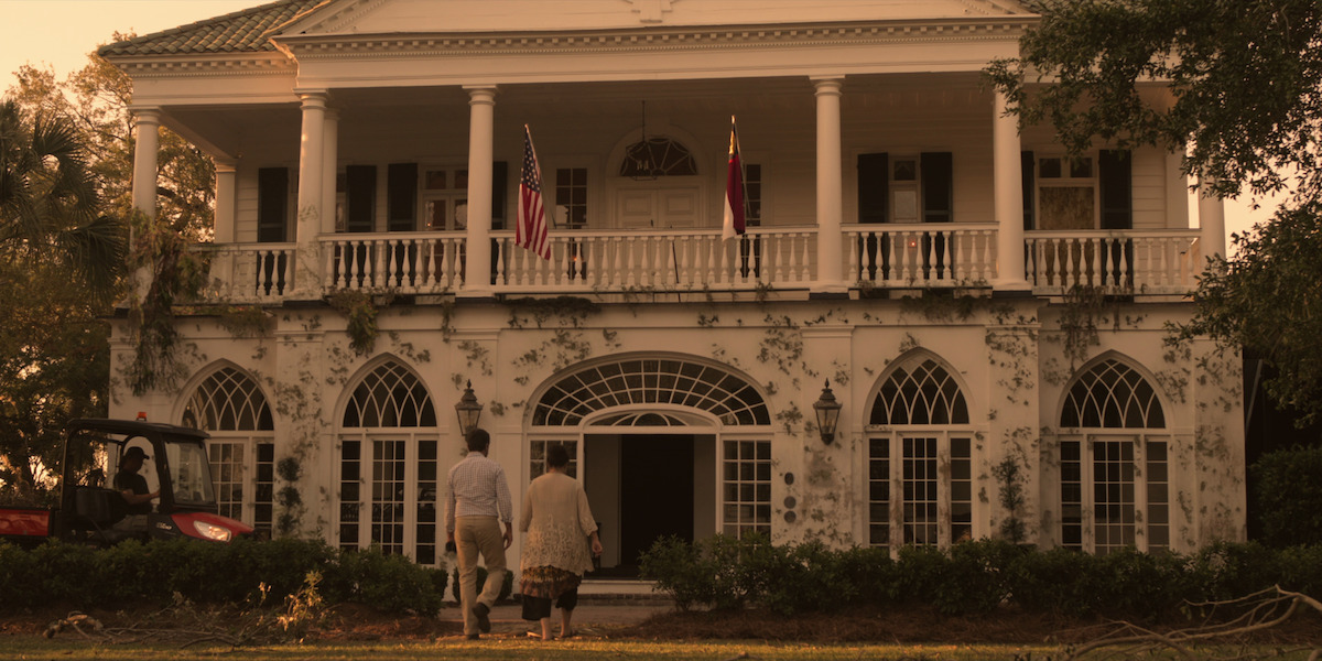 Exterior shot of Tannyhill Estate with white columns and ivy growing up the white building