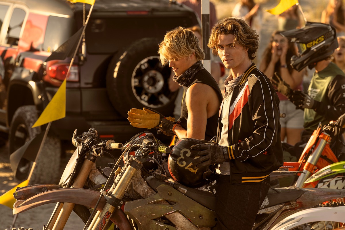 Rudy Pankow as JJ and Chase Stokes as John B riding dirt bikes in ‘Outer Banks’ Season 4.