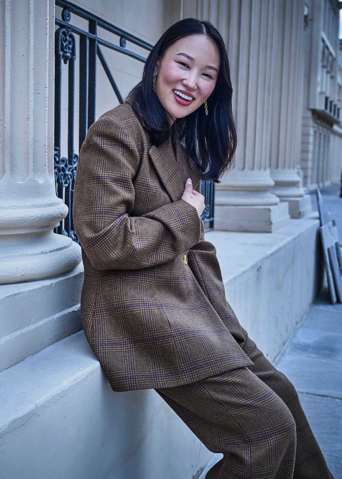 Yerin Ha smiles while posing on a studio lot.