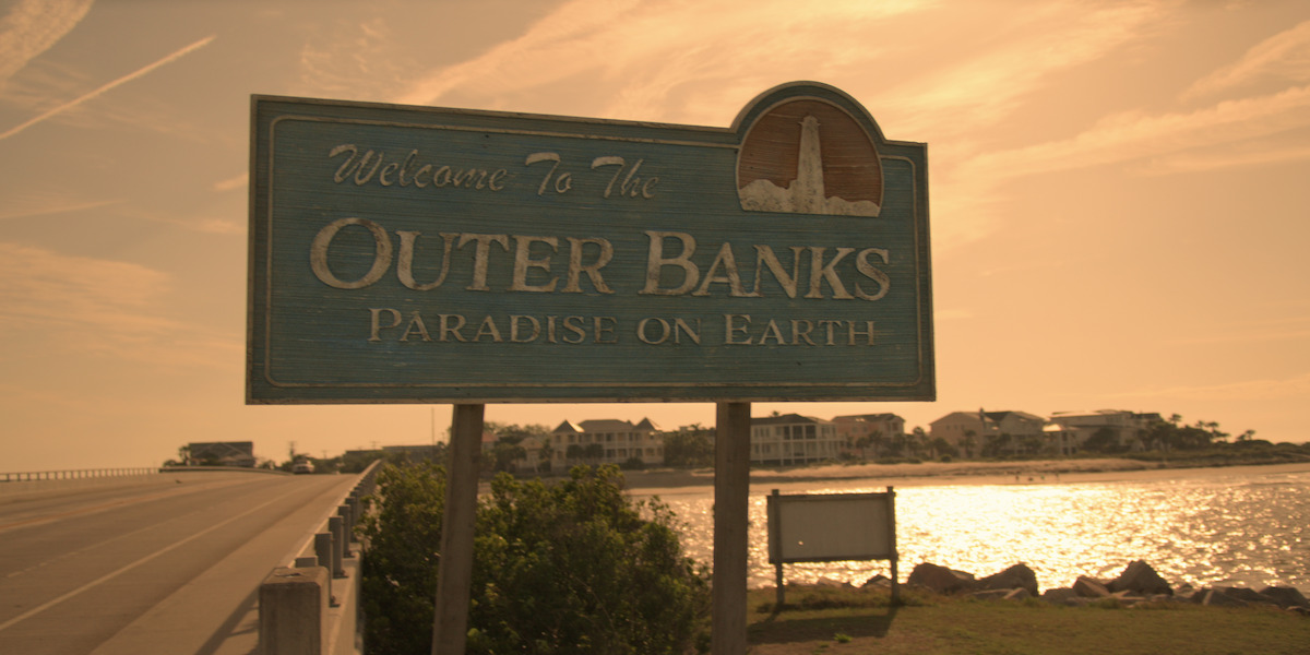 A “Welcome to the Outer Banks, Paradise on Earth” sign greets visitors as they enter Kildare Island.