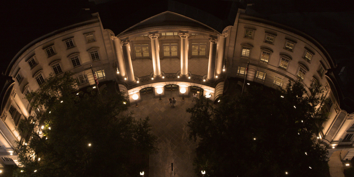 Exterior shot of the UNC Law Library at night with lit-up windows