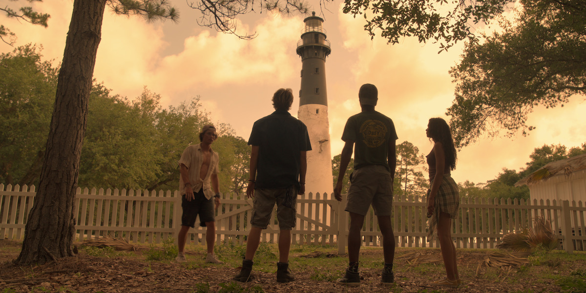 John B, Rudy, Pope, and Kiara stand outside the lighthouse.