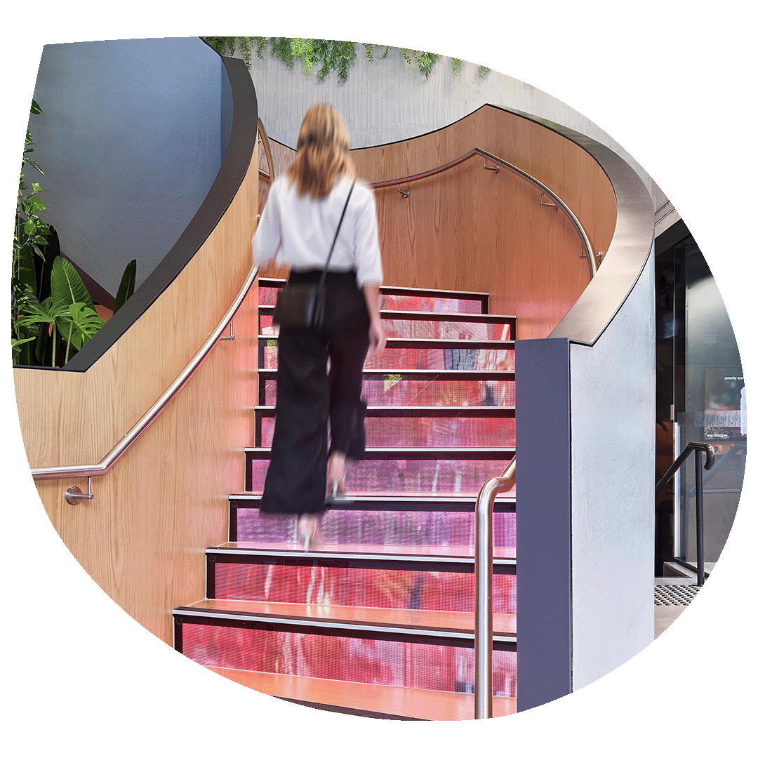 Lady walking up LED riser on a staircase