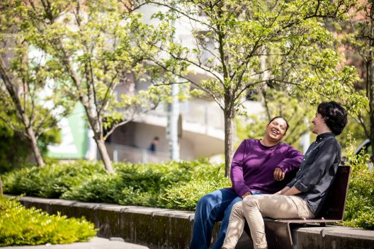 two people laughing together outside the henry art gallery