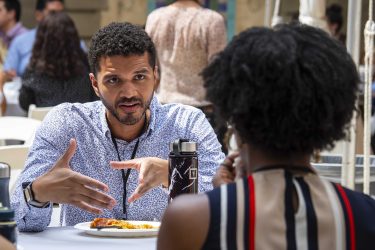 Attendees at the RUA 2022 All-Hands Conference held on the Caltech campus discuss the sessions over lunch.