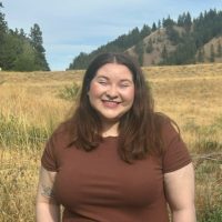 Hailey Smith in front of a field with foothills in the background