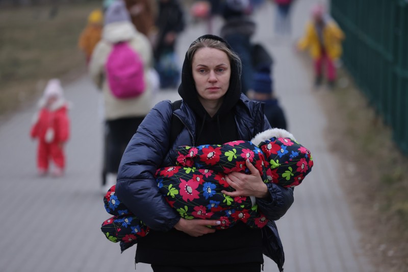 Women and children from Ukraine, including a mother carrying an infant, arrive at the Medyka border crossing near Medyka, Poland, on March 4.