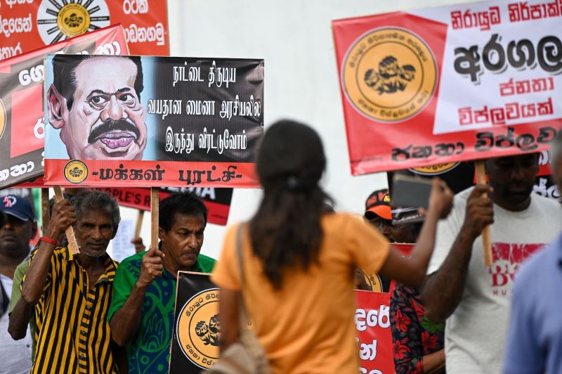 People’s Revolution party activists hold placards during a demonstration in Colombo, Sri Lanka, on Aug. 11.