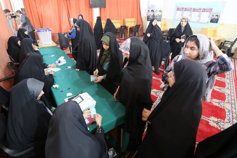 Iranian women arrive to cast their votes at a polling station during the presidential election in Tehran on June 28.