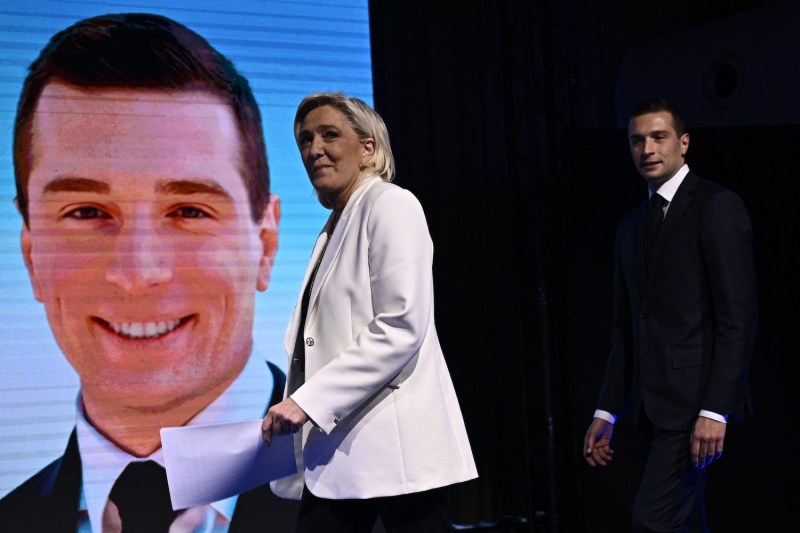 French Rassemblement National (RN) party leader Marine Le Pen (L) followed by party president Jordan Bardella arrives on stage to address supporters in Paris, on June 9.