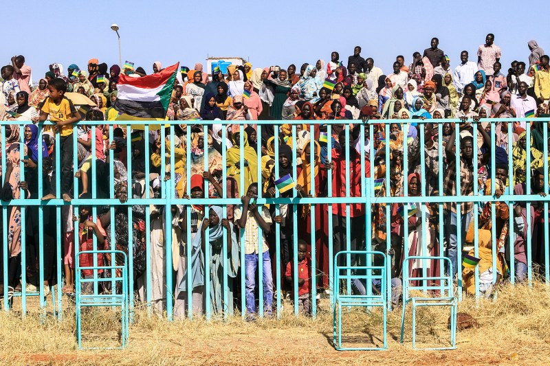 People watch as fighters of the Sudan Liberation Movement, a rebel group active in Sudan's Darfur State, attend a graduation ceremony in the southeastern Gedaref state on March 28.