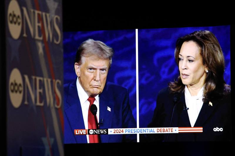 U.S. Vice President Kamala Harris and former U.S. President Donald Trump are seen on a screen as they participate in a presidential debate at the National Constitution Center in Philadelphia on Sept. 10.