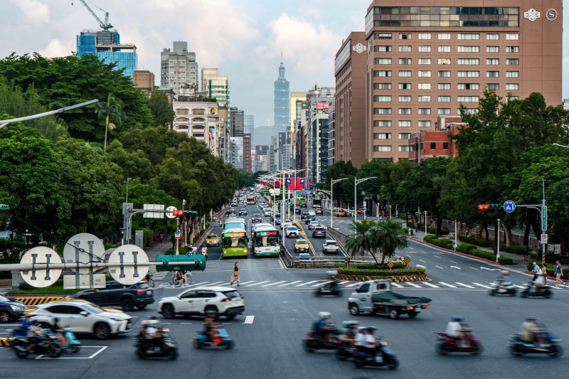 Commuters ride along a street decorated with Taiwanese national flags in Taipei.