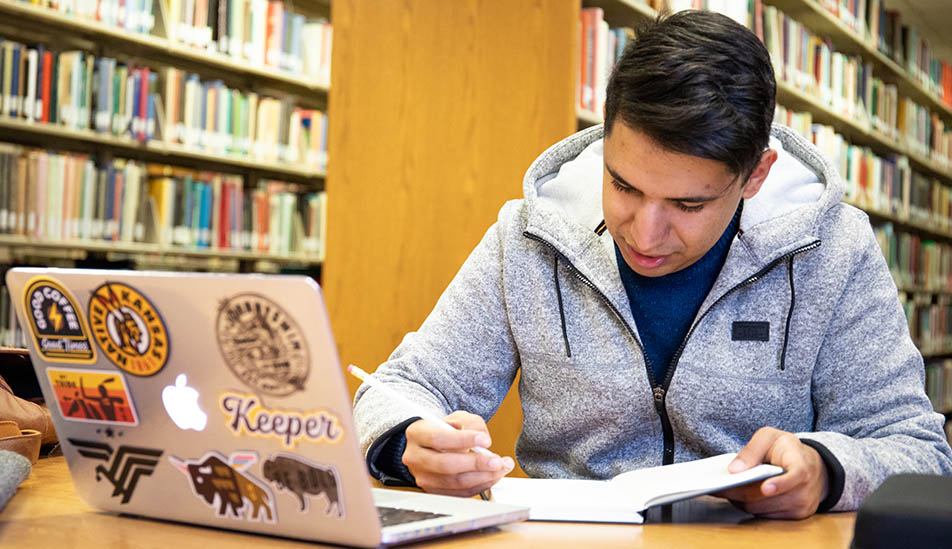 Wichita State student studying in the Ablah Library